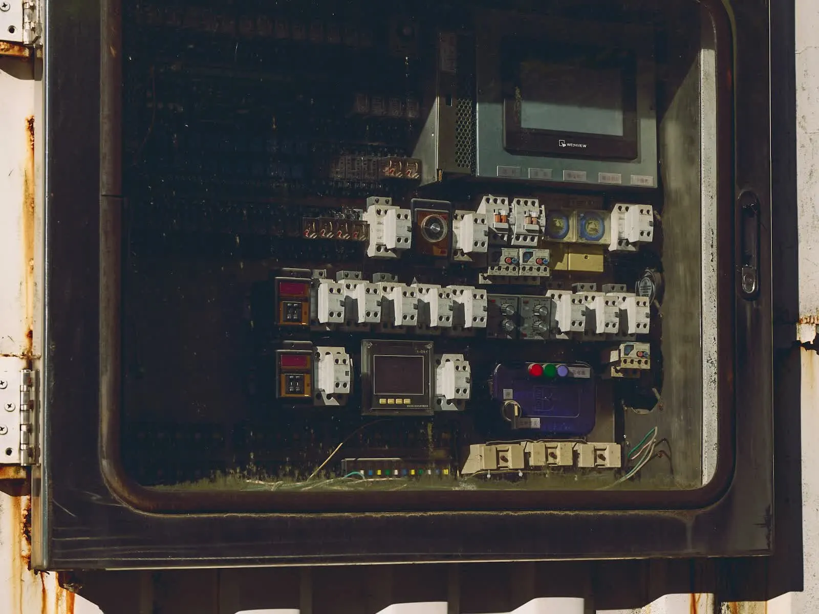 Engineer inspecting electrical control equipment
